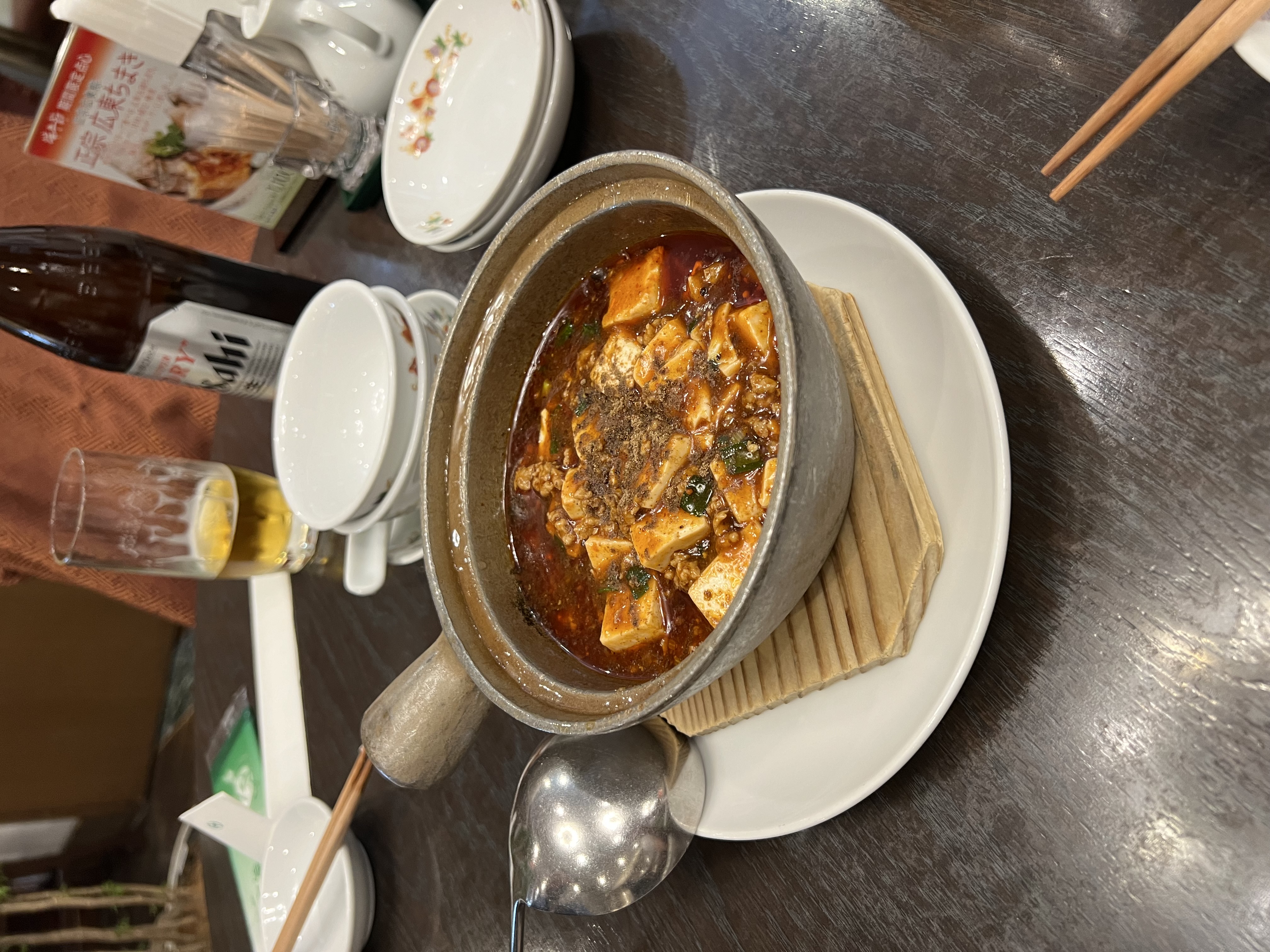 Bubbling mapo tofu in a stone pot at Saikoh Shinkan