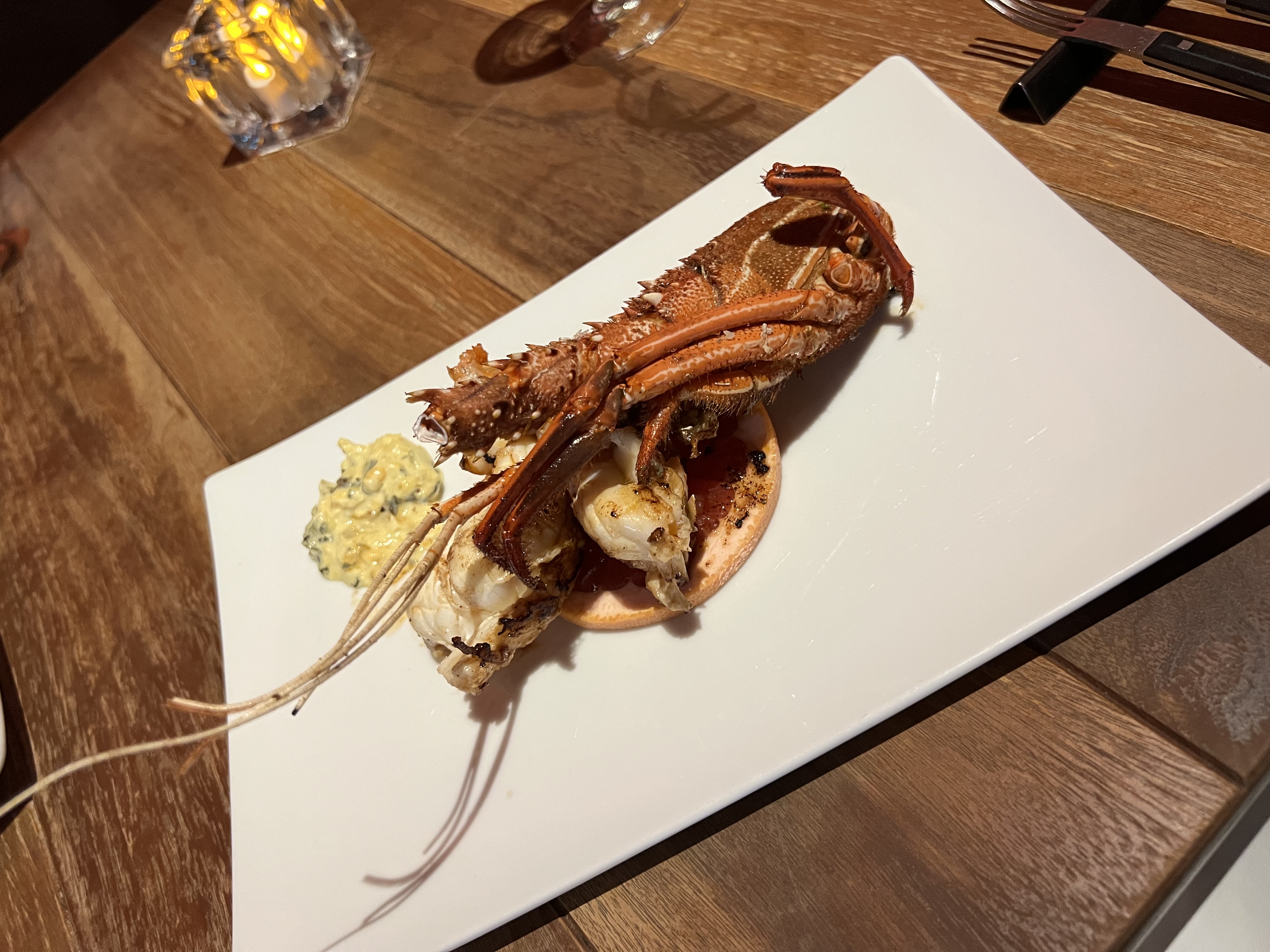 Grilled whole ebi on a white plate